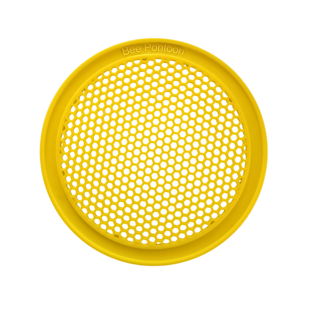 Yellow round plastic bee watering station with honeycomb pattern on a white background