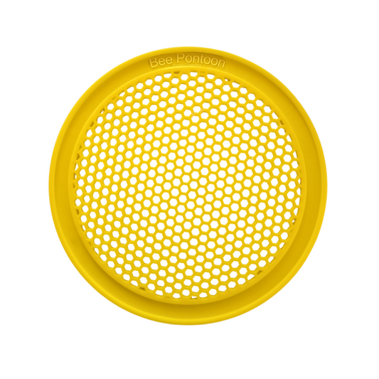 Yellow round plastic bee watering station with honeycomb pattern on a white background