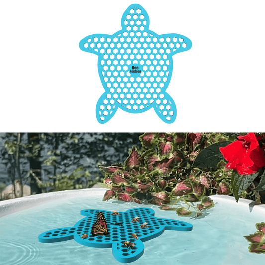 A blue turtle-shaped bee watering station (bee pontoon) in a birdbath against a flower background.