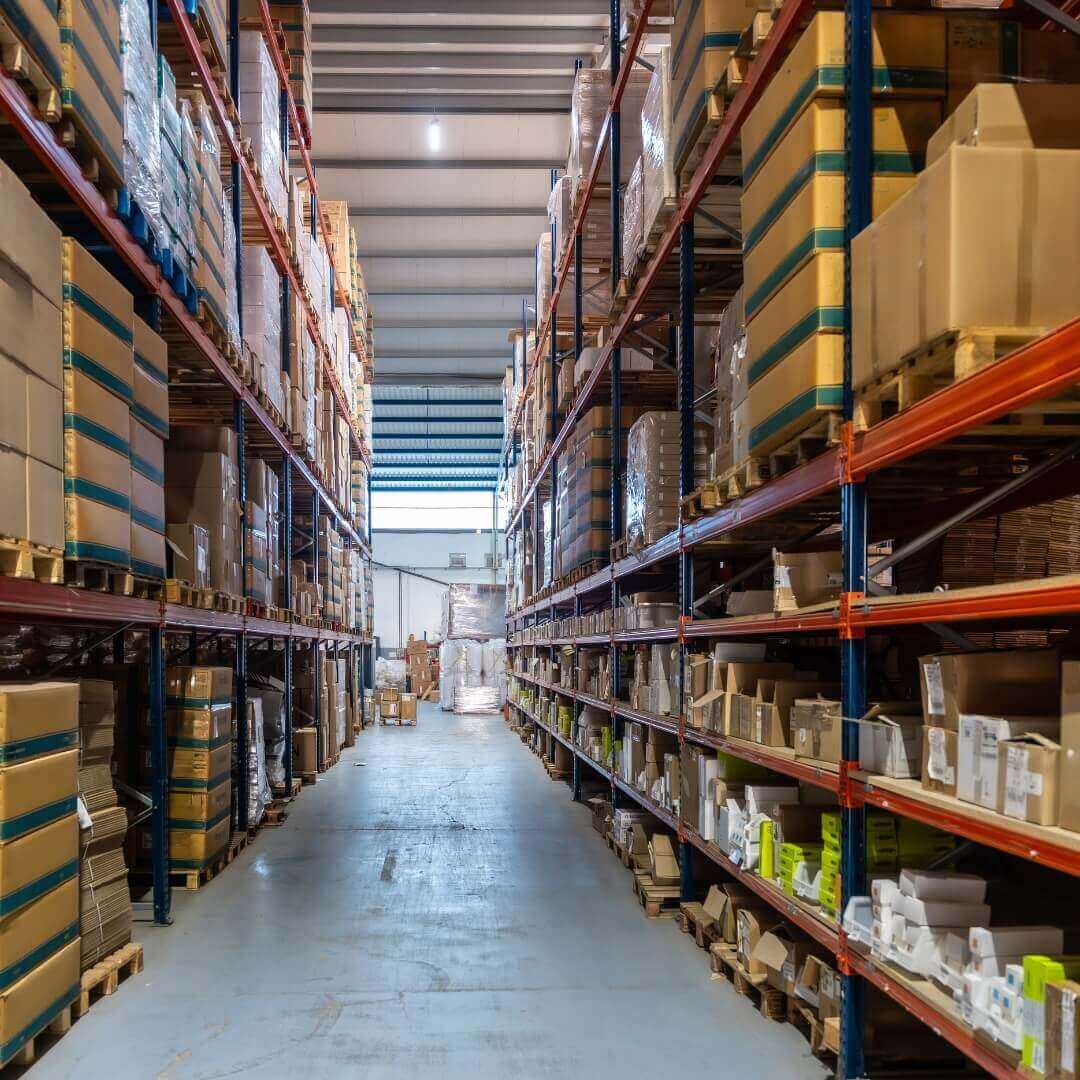 Warehouse interior with shelves stocked with boxes and goods